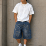 Urbanmore oversized graphic denim shorts for men in vintage washed blue denim with embroidered streetwear design and relaxed fit.